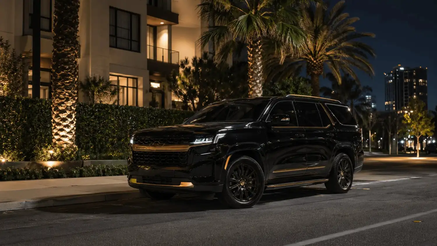 Executive transport SUV positioned outside luxury residential property at night