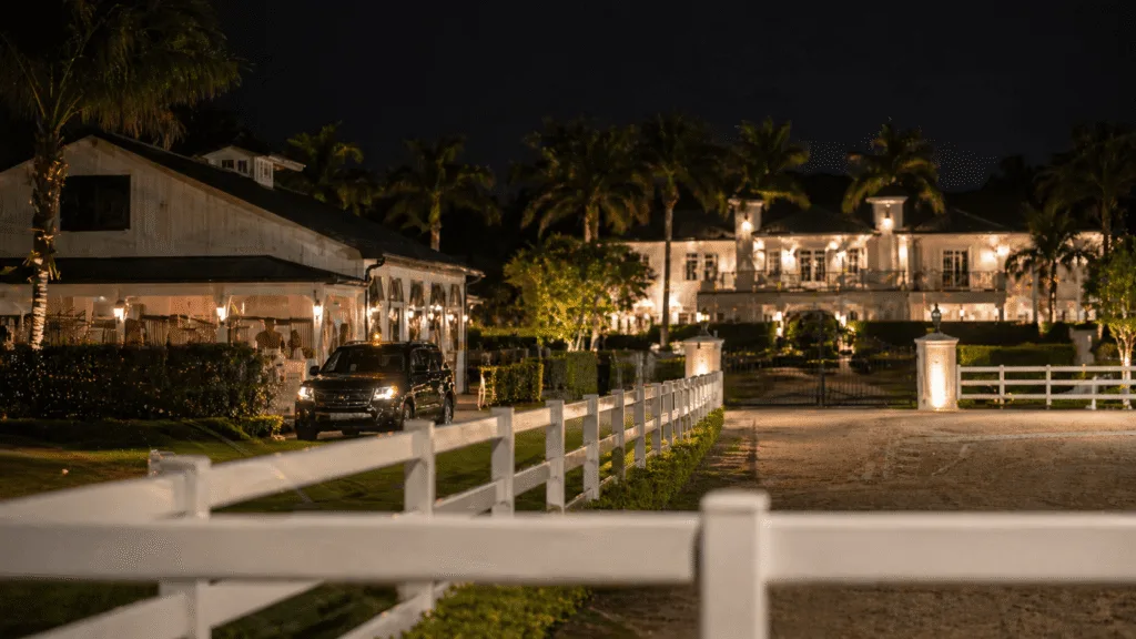 Mobile security patrol SUV at a gated equestrian estate at night in Wellington