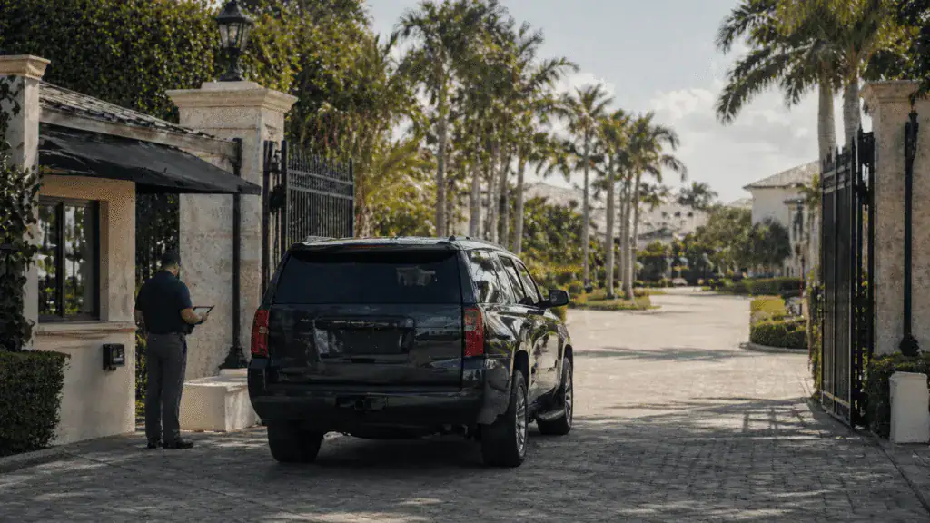 Security staff vetting at a gated community entrance with patrol SUV in Jupiter