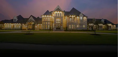 Luxury estate with perimeter security lighting at dusk