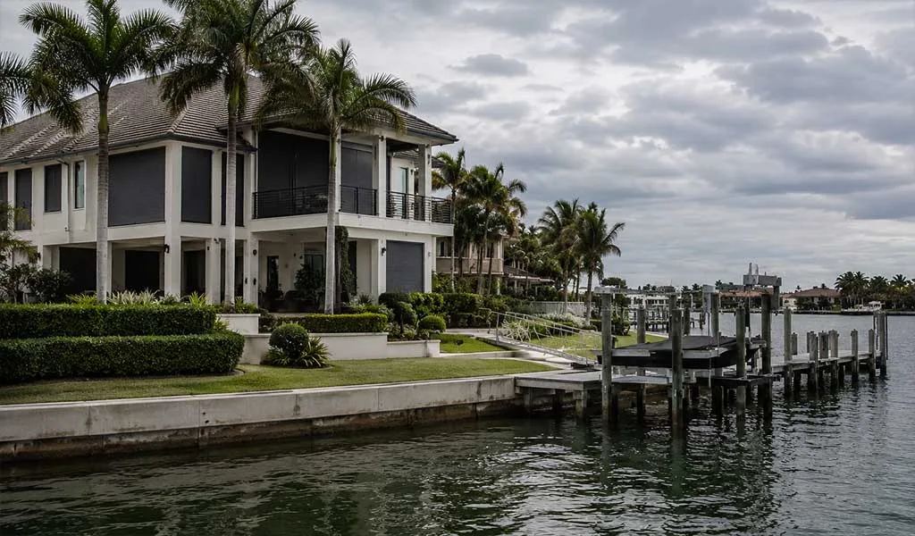 Luxury canal-front estate in Naples with reinforced waterfront infrastructure before hurricane season.