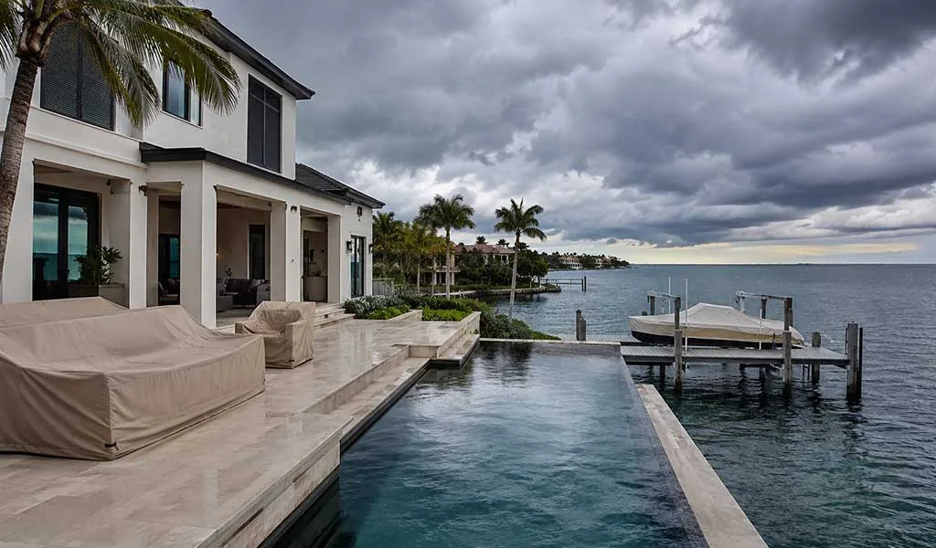 Luxury waterfront estate in Naples prepared for hurricane season along the Gulf Coast.