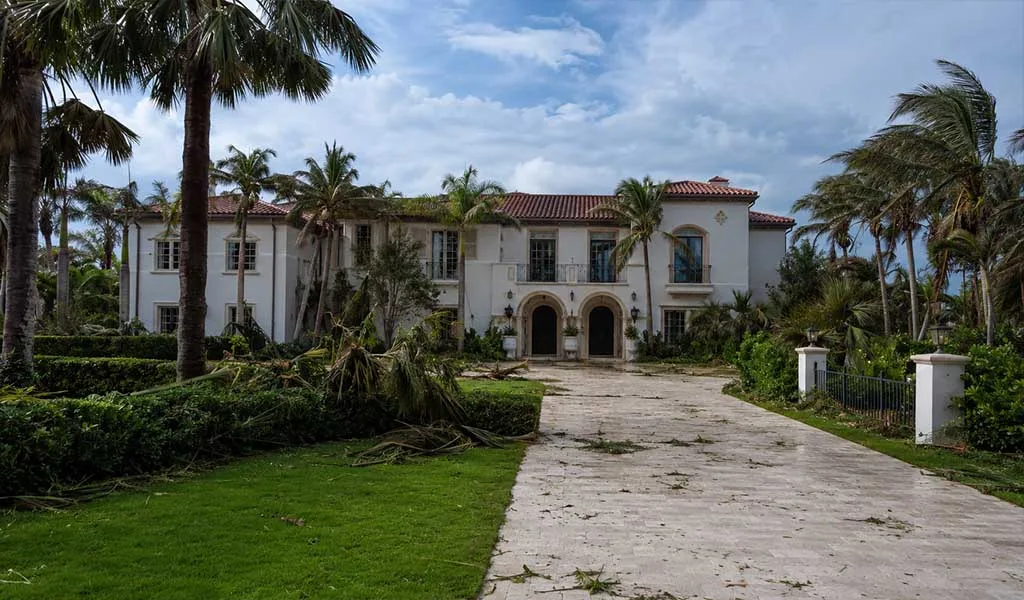 Luxury waterfront estate following a hurricane with cleanup and recovery underway